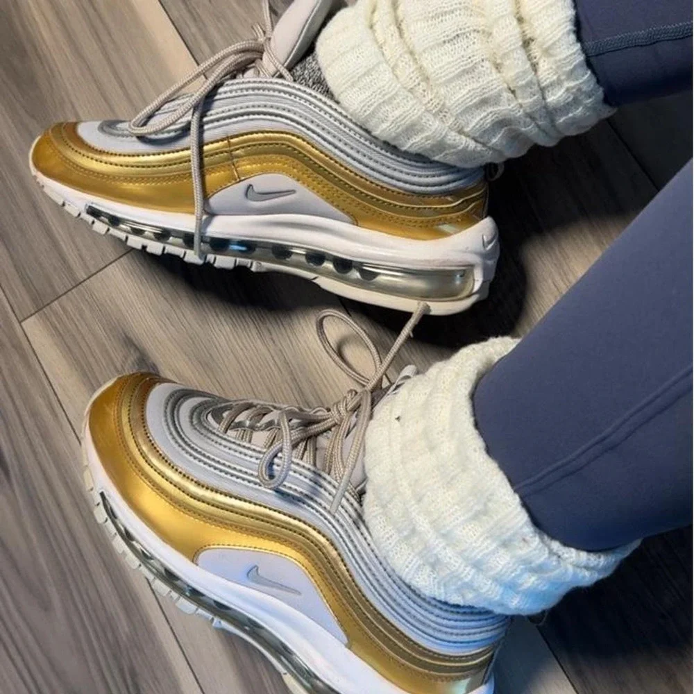 Nike Air Max 97 sneakers in gold and white with silver accents